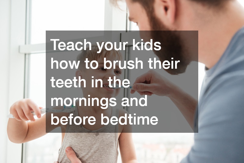 dad teaching son how to brush teeth